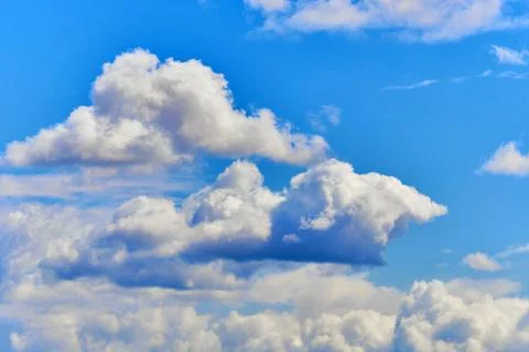 Thick clouds in the blue sky as a background. Stock Photos
