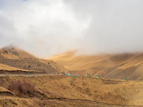 Thick clouds descended on the mighty peaks of the Caucasian mountains on an Stock Photos