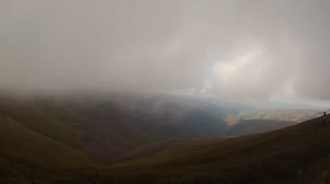 Thick Clouds Floating Over Valley at Bottom. View From Mountain Top Stock Footage 63950933