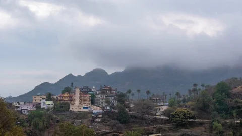Thick clouds fly over the mountain village. Timelapse Stock Footage 128521007