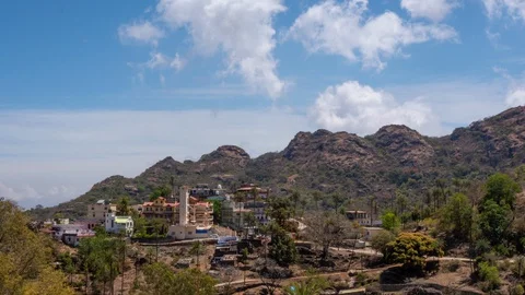 Thick clouds fly over the mountain village. Timelapse Stock-Footage 129223642