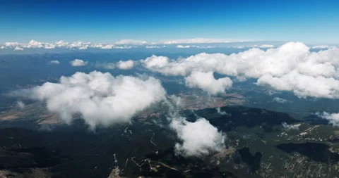 Thick clouds hover over mountain range Stock Footage 303317644