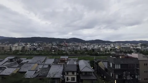 Thick clouds in the sky and streets along the Kamo River Stock Footage 336519658