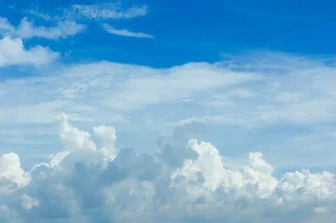 Thick clouds in summer blue sky. Cloudy bright beauty in the sun, bright an.. Stock Photos