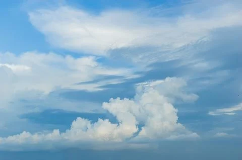 Thick clouds in summer blue sky. Cloudy bright beauty in the sun, bright an.. Stock Photos