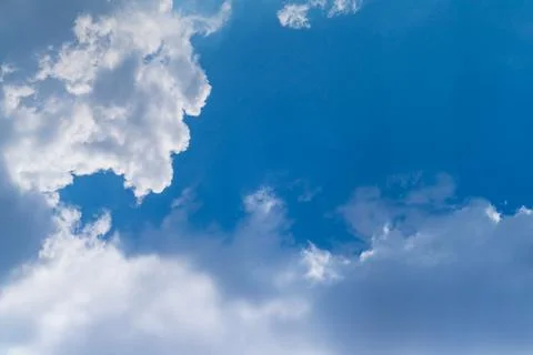 Thick clouds, translucent in the sun against a blue sky with flashes and an e Stock Photos