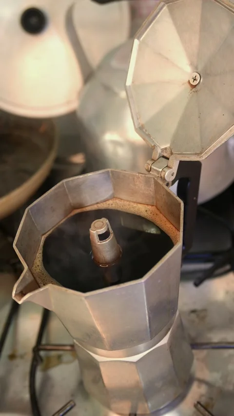 Thick coffee steam rises intensely from a coffee maker. Moka pot boiling Stock Footage 342003828