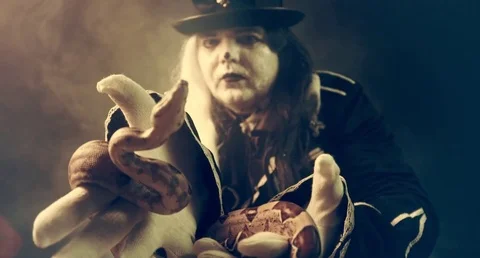Thick crazy actor in white makeup with a snake. Masquerade. 動画素材 70984690
