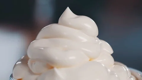 Thick cream is extruded in a dish Stock Footage