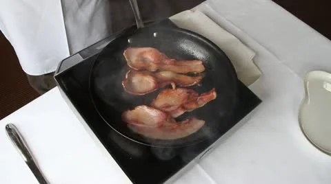 Thick cut bacon in frying pan Stock Footage 21528339