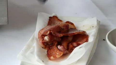 Thick cut bacon transferred to white plate Stock Footage 21528363