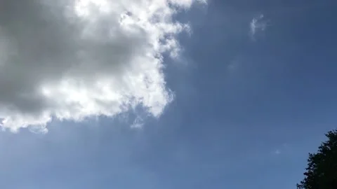 Thick Dark Cloud Against Blue Skies on a Sunny Day Stock Footage 138018214