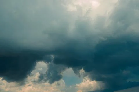 Thick dark clouds fill sky, showing signs of approaching storm. mix of gray a Stockfoto's