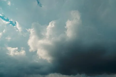 Thick dark clouds fill sky, showing signs of approaching storm. mix of gray a Stock Photos