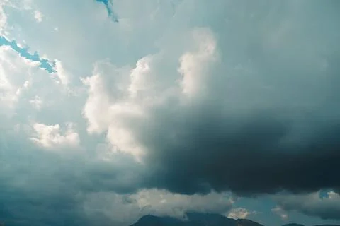 Thick dark clouds fill sky, showing signs of approaching storm. mix of gray a 写真素材