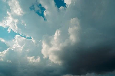 Thick dark clouds fill sky, showing signs of approaching storm. mix of gray a 写真素材
