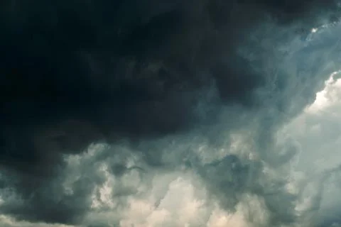Thick dark clouds fill sky, showing signs of approaching storm. mix of gray a 写真素材