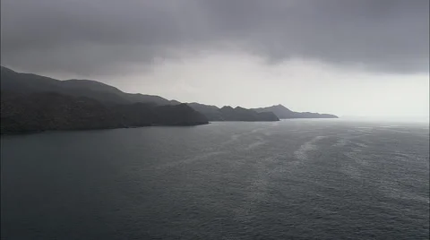 Thick dark clouds over rocky coast Stock Footage 66824412