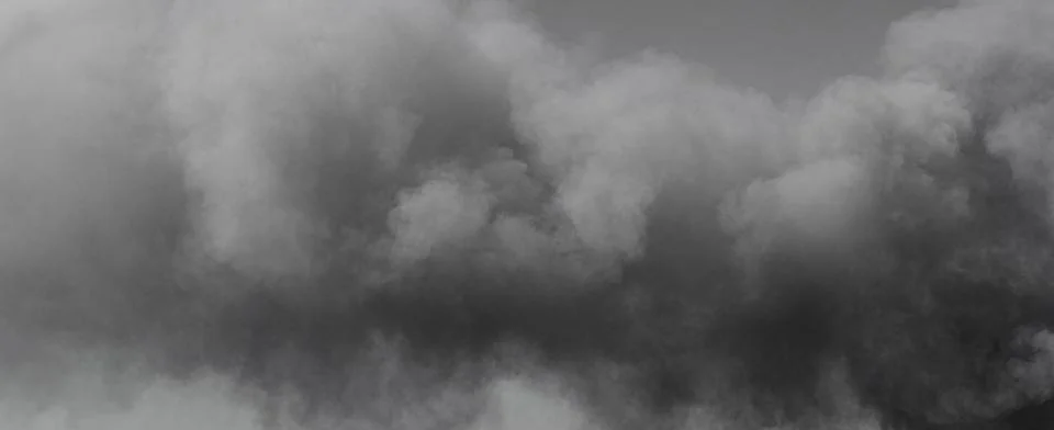 Thick dark smoke clouding sky creating pollution Stock Photos