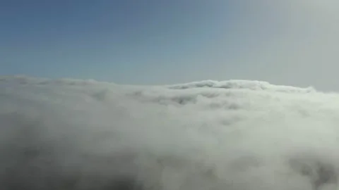 Thick dense clouds stretch from the horizon Through small holes in the fog the Stock Footage 131739837