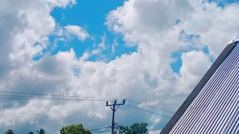 Thick Dramatic Clouds Over Countryside Village At Midday Stock-Fotos