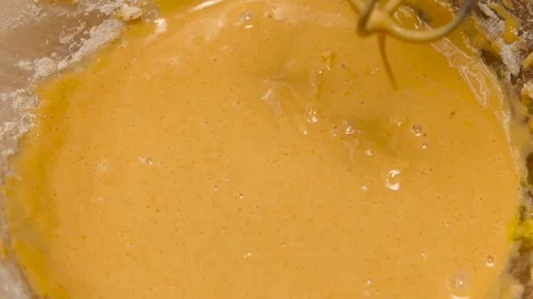 Thick egg dough is whipped with electric mixer, slow motion Stock Footage 76167646
