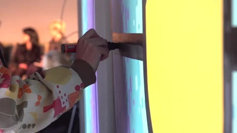 With a thick, fat, black felt-tip pen, a graffiti artist's hand draws lines Stock Footage 240750373