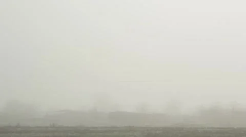 Thick Fog Covers a Multitude of Buildings Nature Reserve and Bare Trees Stock Footage 62509745
