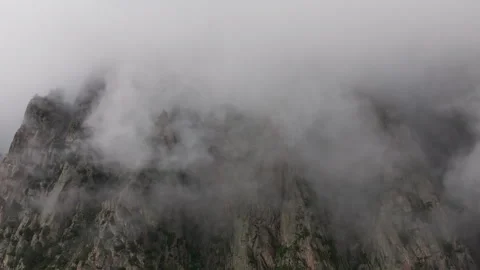 Thick fog moving quickly over mountain peak Stock Footage 289664273