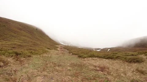 Thick Fog Over the Withered Grass on the Mountainside Stock Footage 63960982