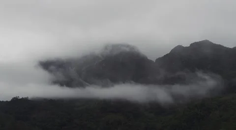Thick Fog Rolling Over Dark Mountains at Doi Luang Chiang Dao Stock Footage 338339719