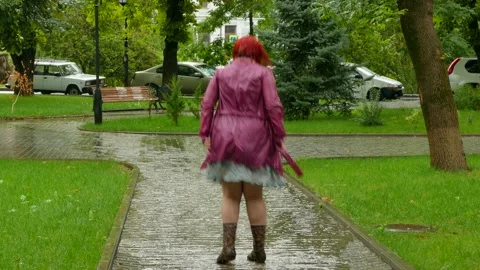 Thick girl jumping in a puddle Stock Footage 86151750