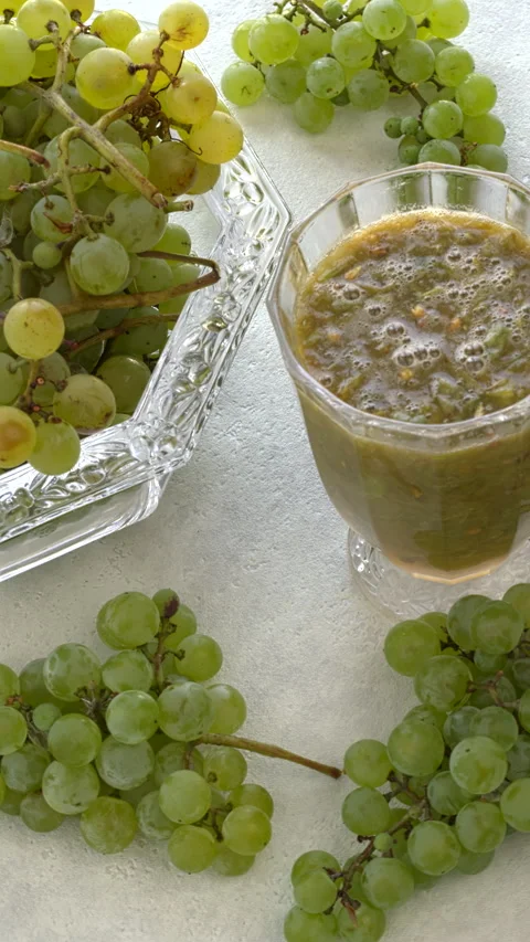 Thick grape drink and bunches of grapes. Vertical video. Stock Footage 284088418
