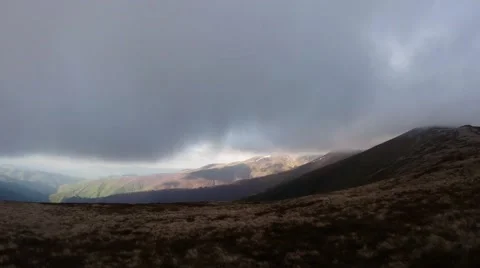 Thick Gray Cloud Almost Touches the Tip of the Mountain Stock Footage 63950182