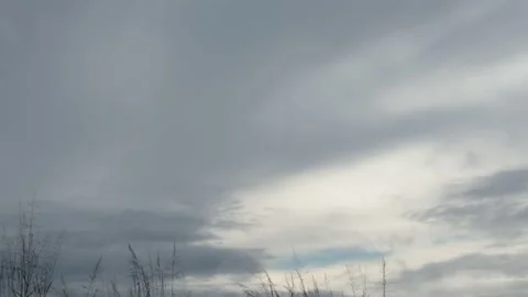 Thick gray clouds advancing through a cloudy rainy sky time lapse Stock Footage 222002918