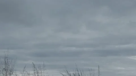 Thick gray clouds advancing through a cloudy rainy sky time lapse Stock Footage 222003140