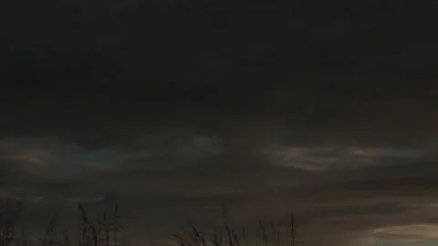 Thick gray clouds advancing through a cloudy rainy sky time lapse Stock Footage 222003584