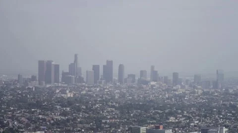 Thick gray smog covers the city skyline during morning Stock Footage 329666953