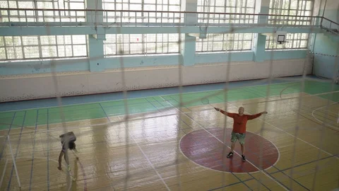 Thick Guy Makes Hands with a Badminton Racket, Draws Attention Stock Footage 91630278