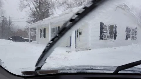 Thick ice on a windshield wiper. 库存照片