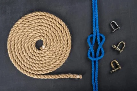 Thick jute rope coiled in the shape of a circle, shackles and a simple knot.  写真素材