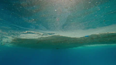 Thick layer of greasy oil mixed with plastic waste floats on turquoise water 動画素材 331106956