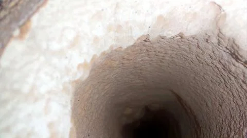 Thick Layer of Limestone Inside a Rugged Pipe in a Geological Formation Stock Photos