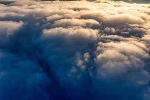Thick layer of white clouds above mountains at sunrise Stock Photos