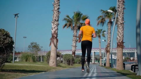 Thick man does running jogging workout sunny morning Stock Footage 247700454