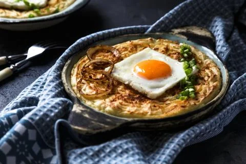 Thick mashed potatoes with sunny side egg, copy space. Stock Photos