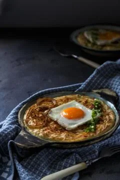 Thick mashed potatoes with sunny side egg, copy space. Stock Photos