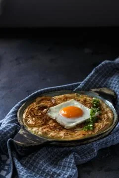 Thick mashed potatoes with sunny side egg, copy space. Stock Photos