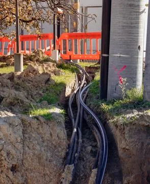 Thick power cable in the ground - electrical tunnel at the high voltage pole Stock Photos