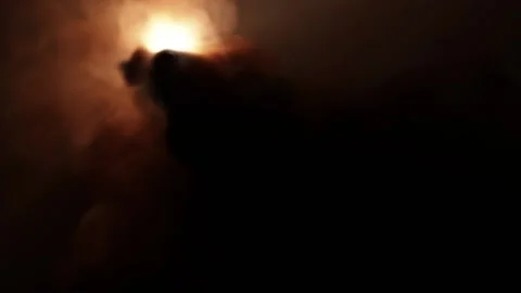 Thick puffs of black smoke make it impossible to see a glowing unidentified Stock Footage 169674308